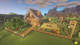 Minecraft survival starter base with a fenced wheat farm and wooden cobblestone house